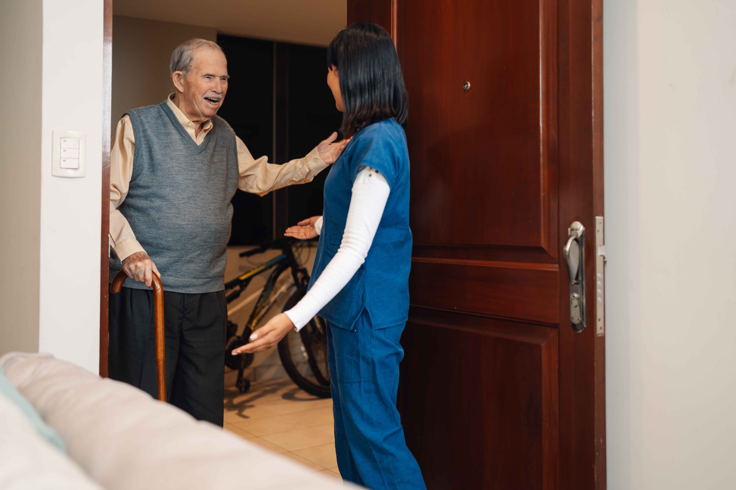 old-man-greeting-a-nurse-arriving-for-a-home-visit-2025-03-06-05-33-16-utc_11zon